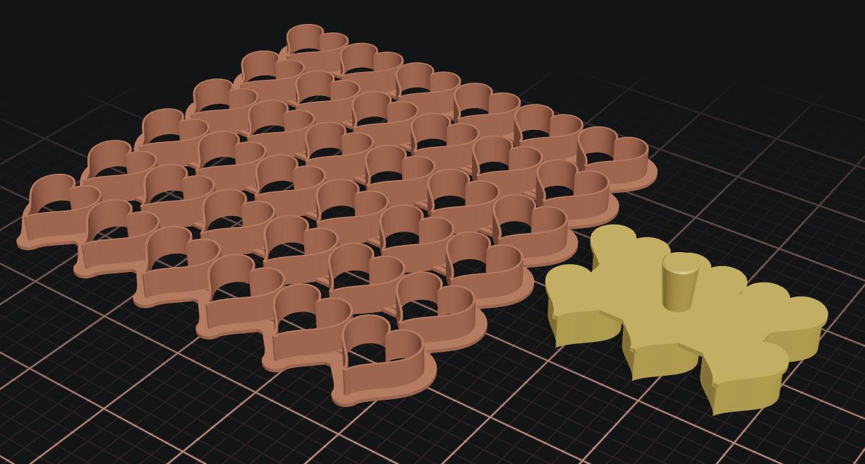 A tray of many cookie cutter shapes generated as a single multi-cutter grid